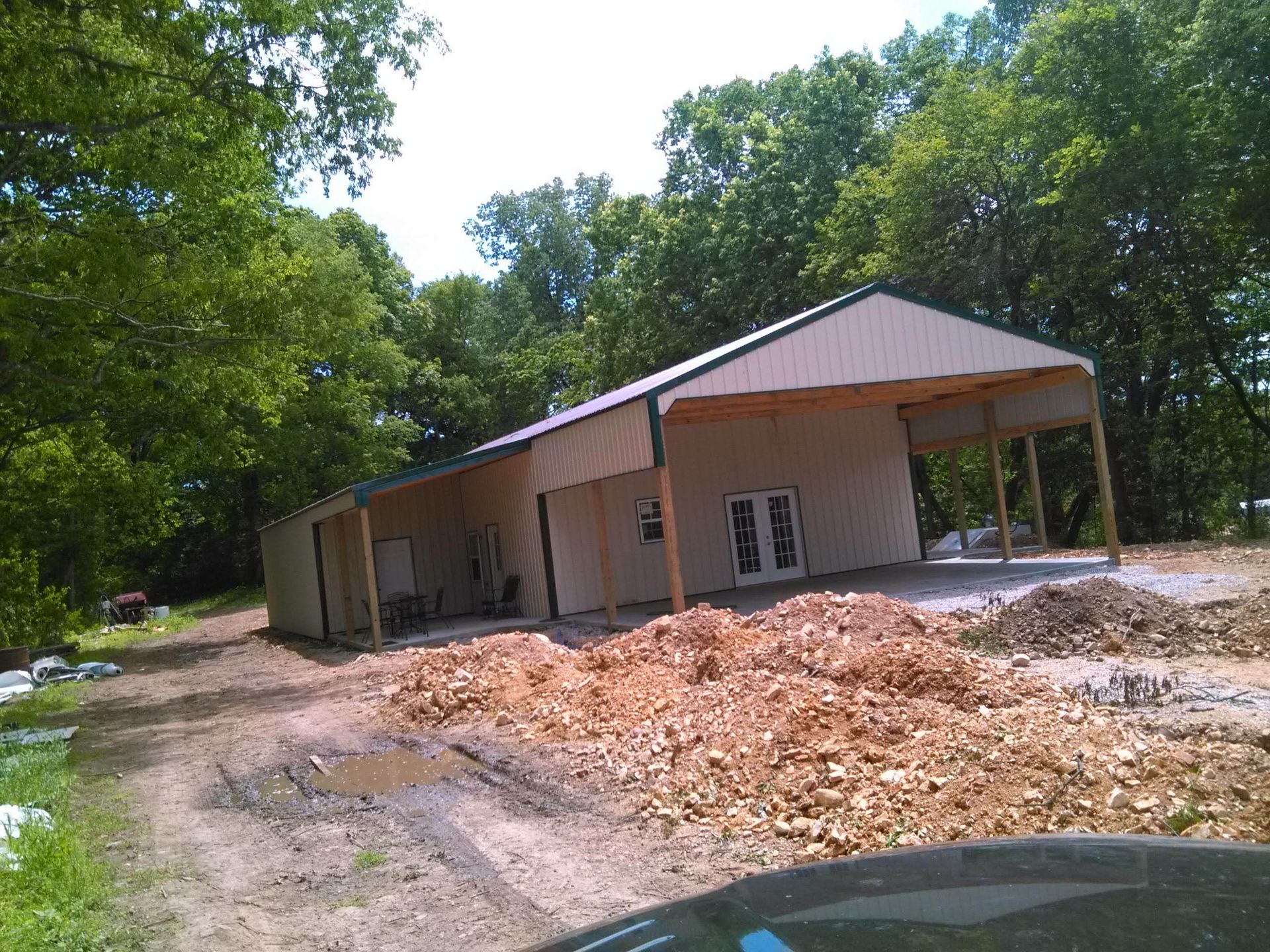 A building under construction with a lot of dirt in front of it