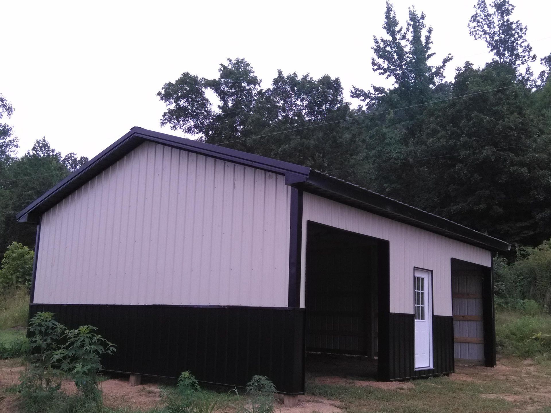 A white and black building with a white door