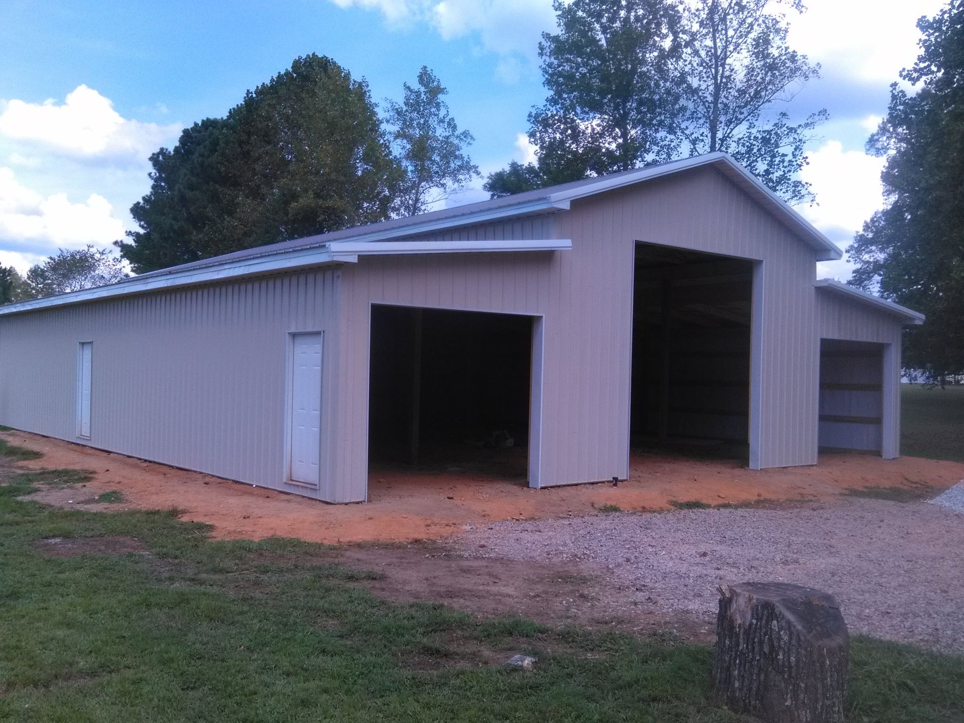 A large barn with two doors and a roof