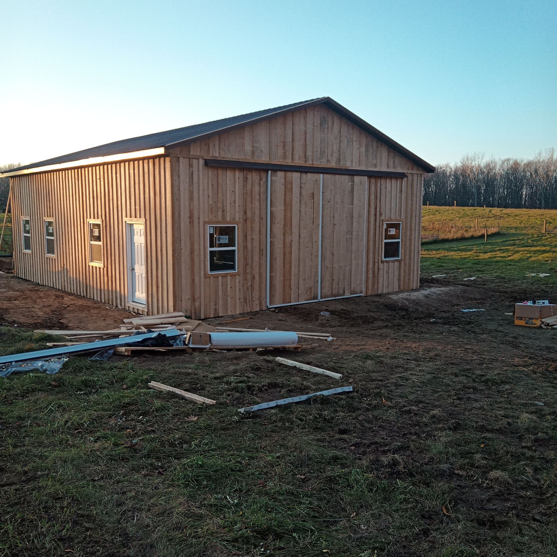 A large wooden building with a sliding barn door