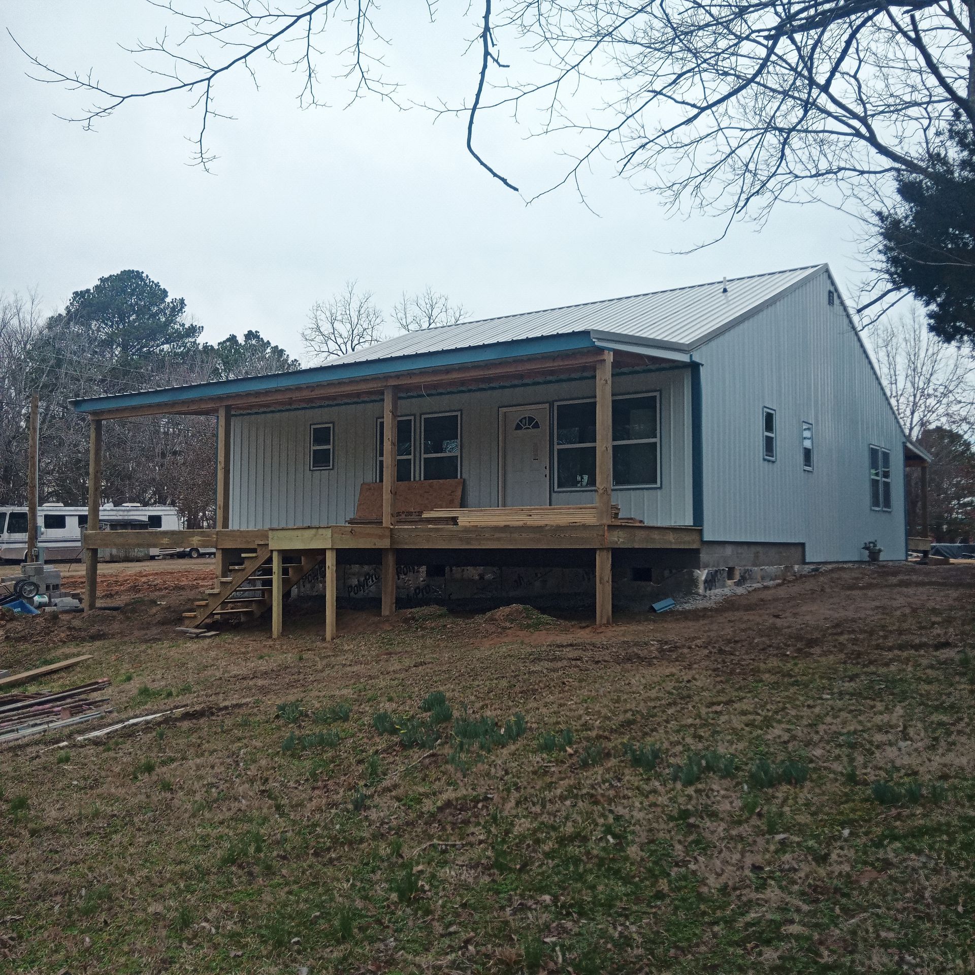 A white house with a blue roof and a porch