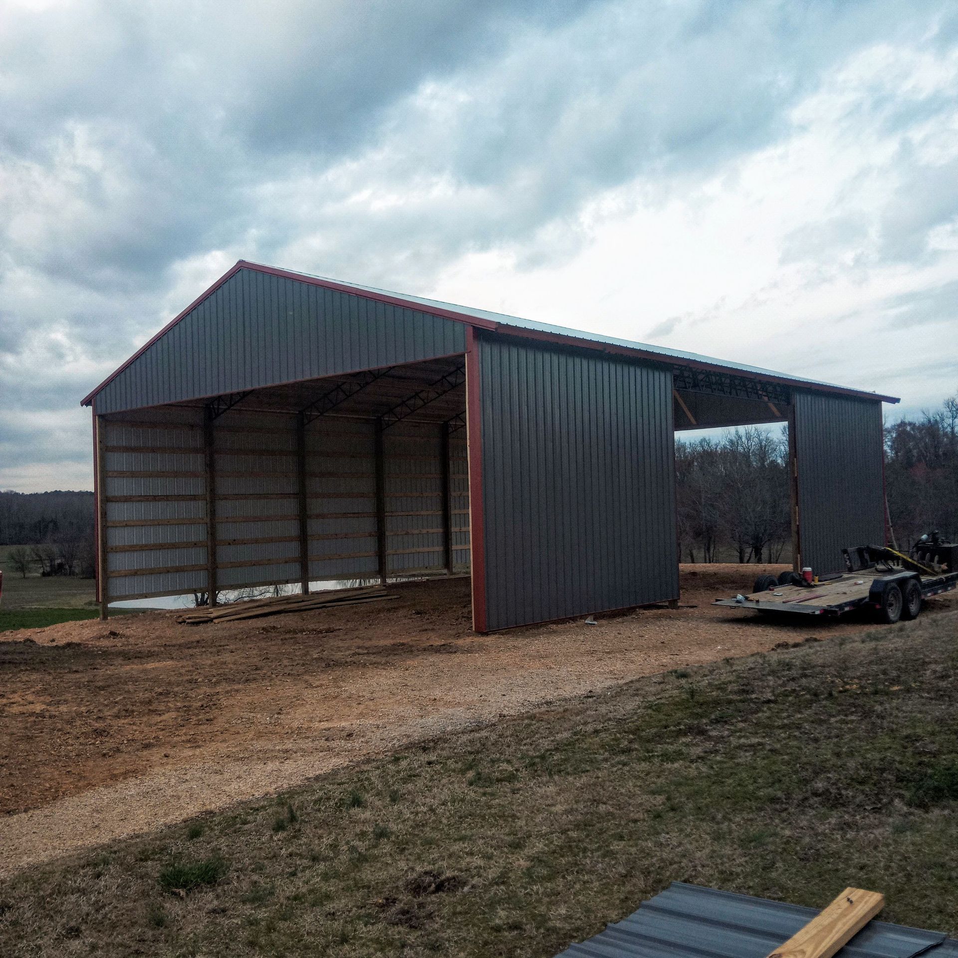 A large metal building with a trailer parked in front of it