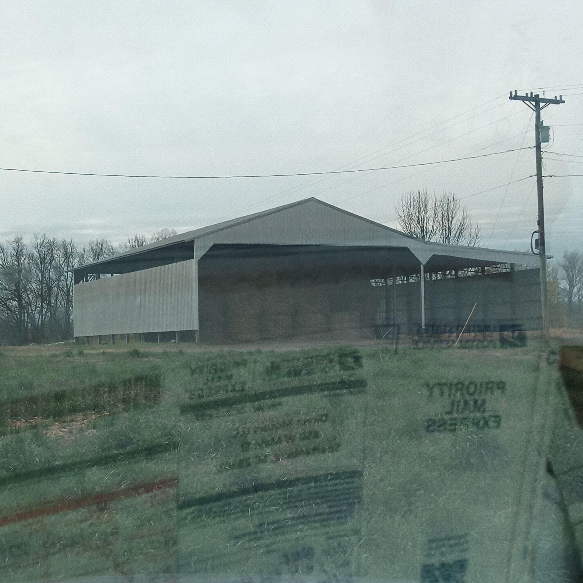 A building in a field with a reflection of a virginia license plate