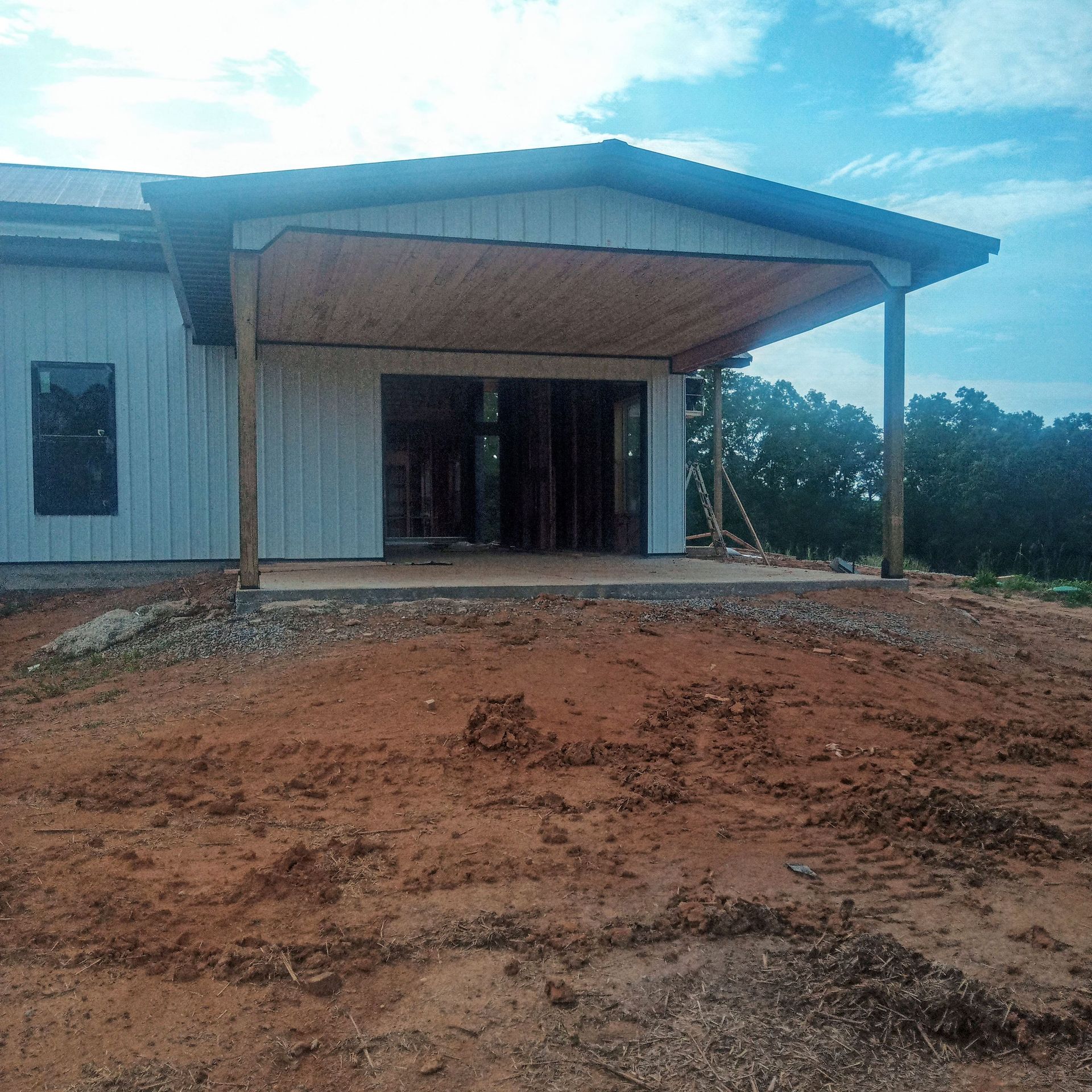 A white house with a blue roof and a porch