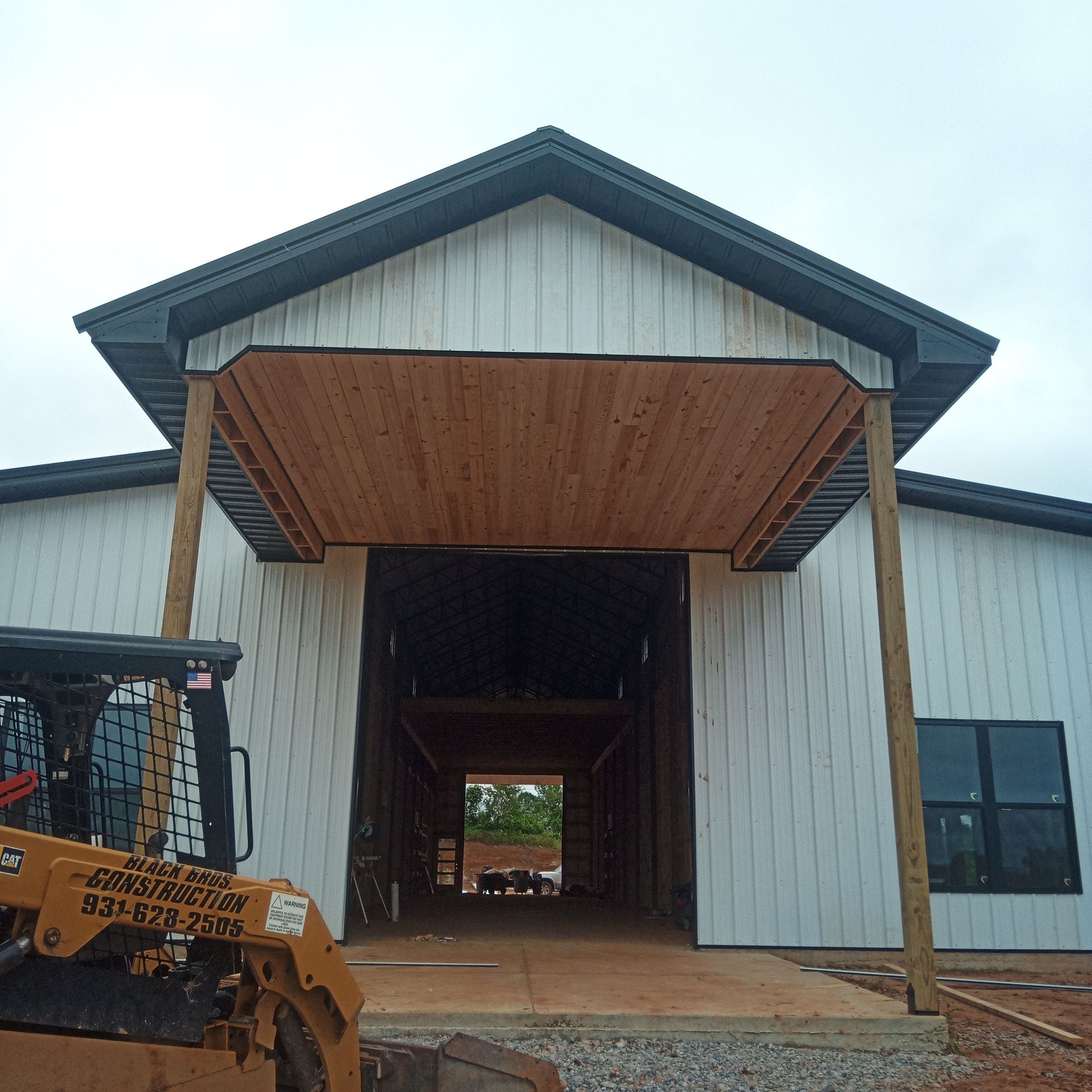 A bulldozer is parked in front of a building that is under construction