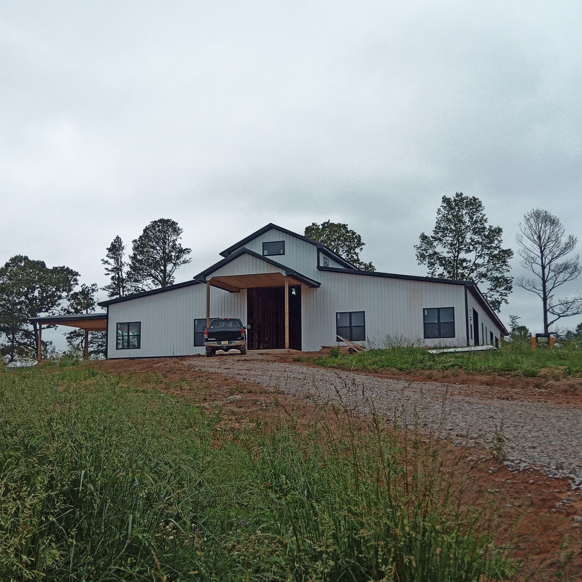 A white house with a black truck parked in front of it