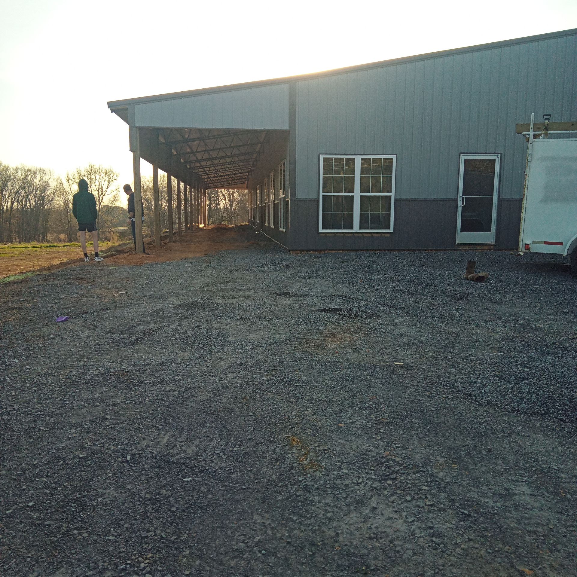 A man is walking in front of a large building