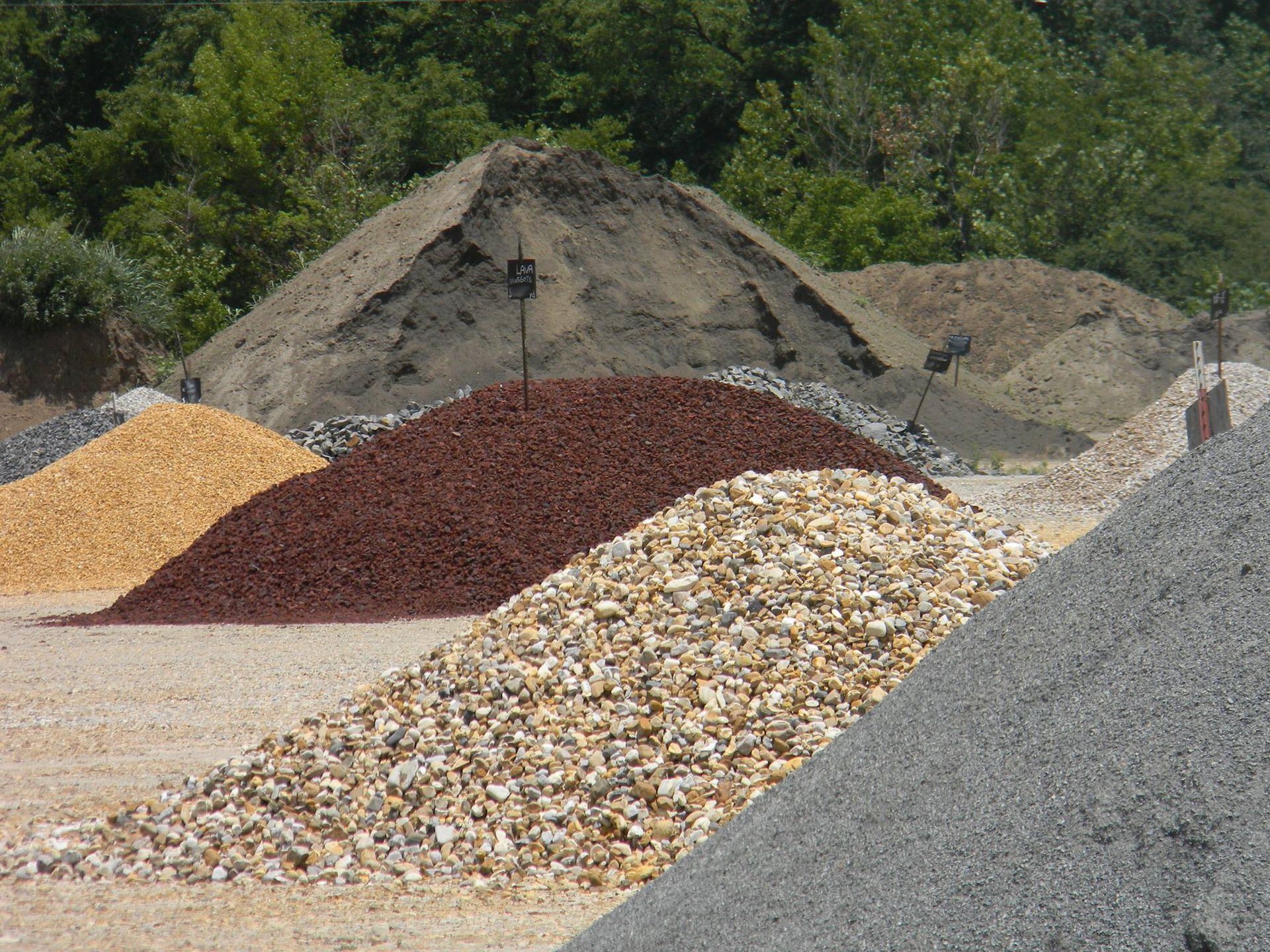 A pile of gravel is sitting on top of a pile of dirt.