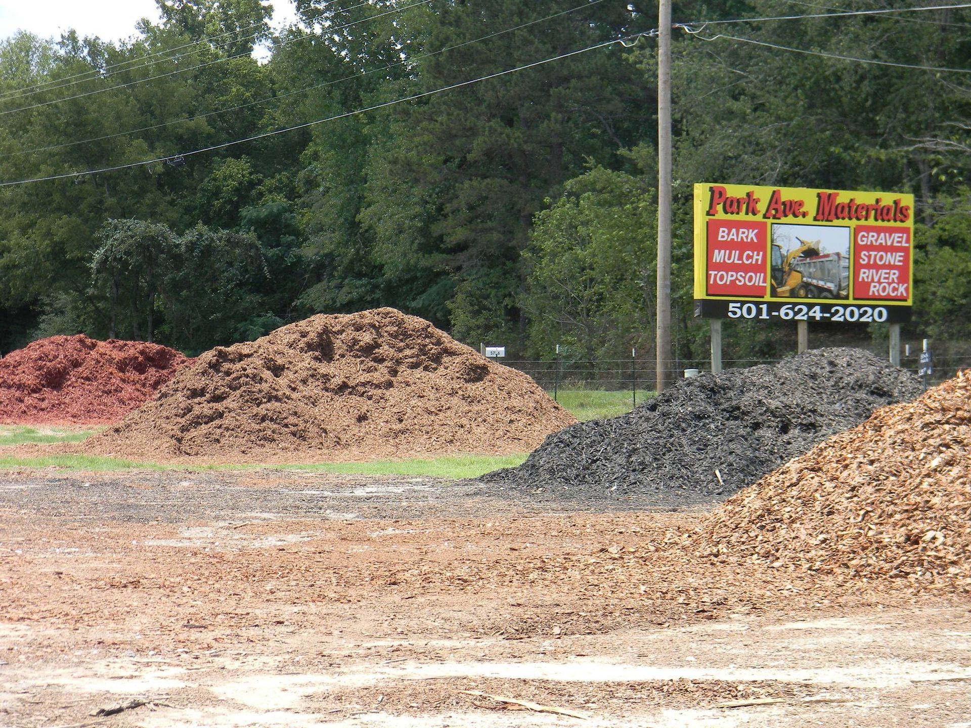 Piles of dirt and a sign that says post ave. materials