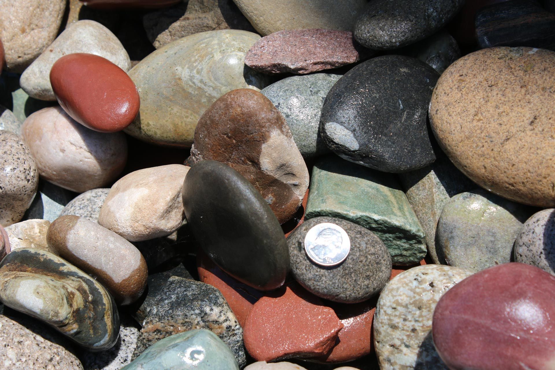 A pile of rocks with one that has the letter g on it