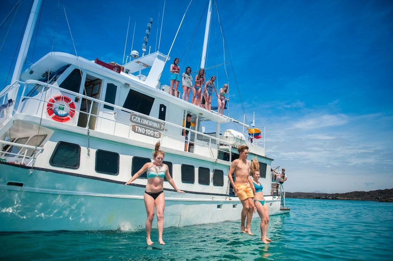 tour boat on the ocean, people jumping off