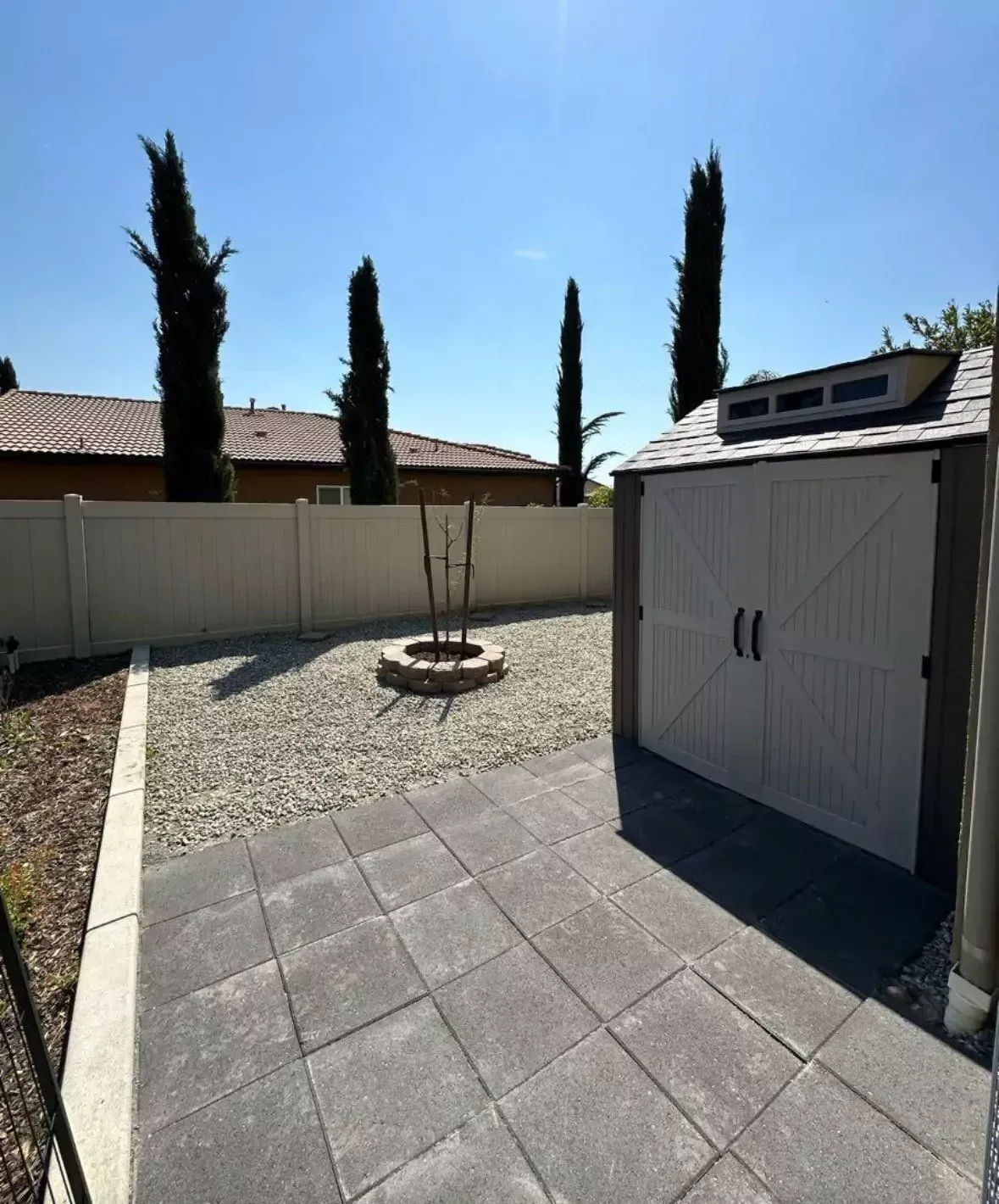 Large patio installation with pavers and stone accents