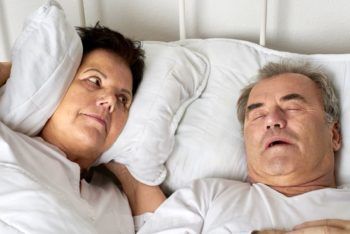 man snoring in bed