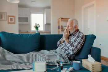 man at home sick on the couch