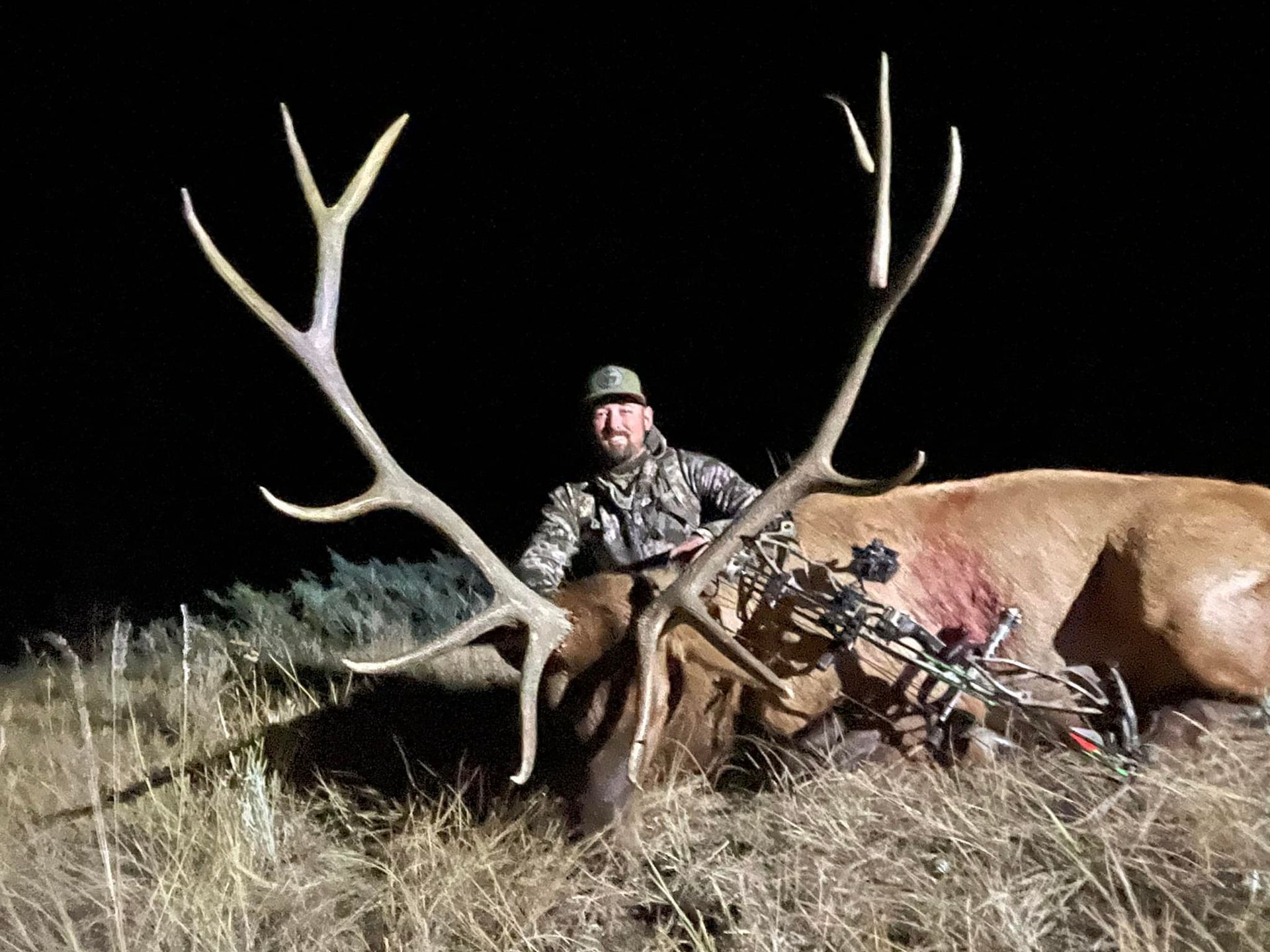 Man posing with deer in a forest