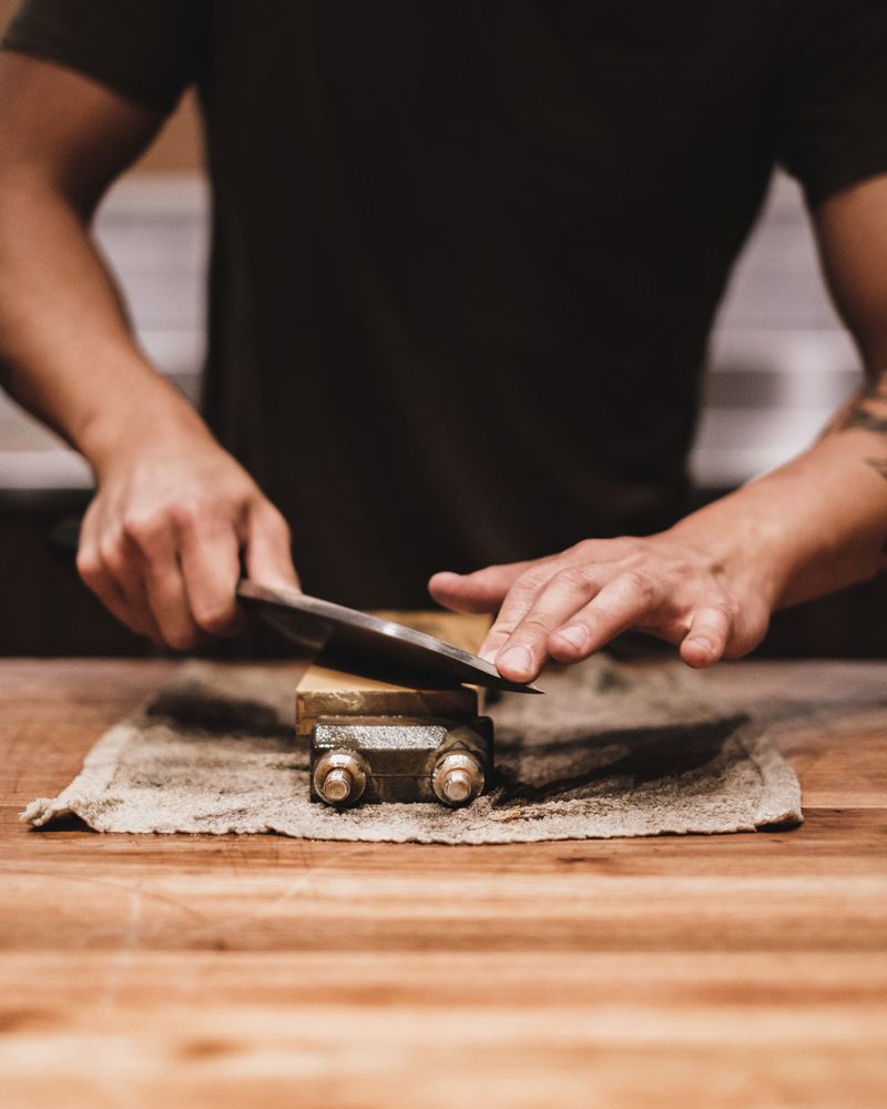 Man Sharpening Knife Using Whetstone — Mobile Scissor Sharpening in Ilkley, QLD