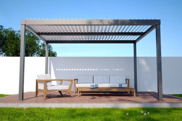 A pergola with a couch and chairs underneath it