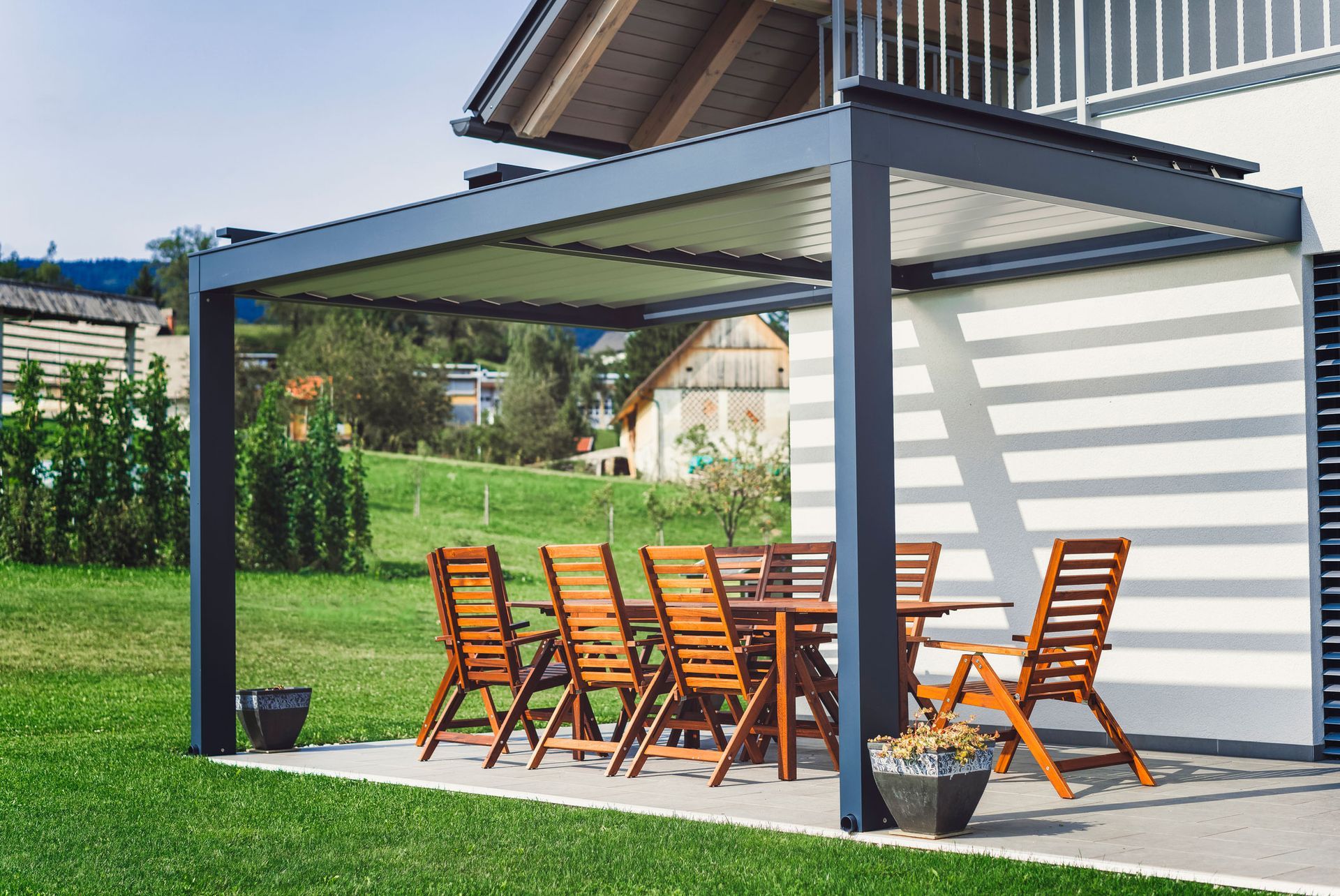 A patio with a table and chairs under a pergola.