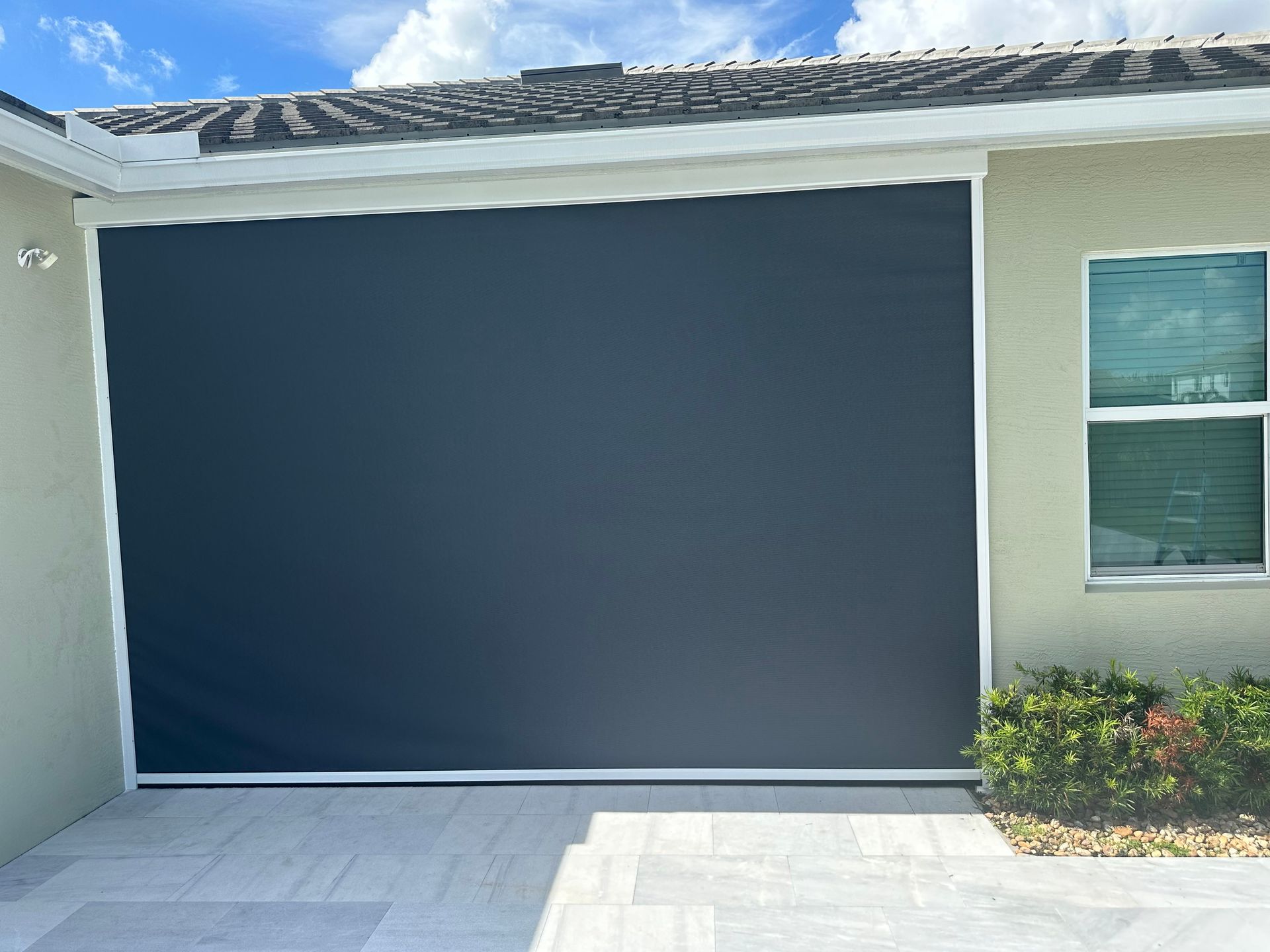 A room with a lot of windows and a view of a city.