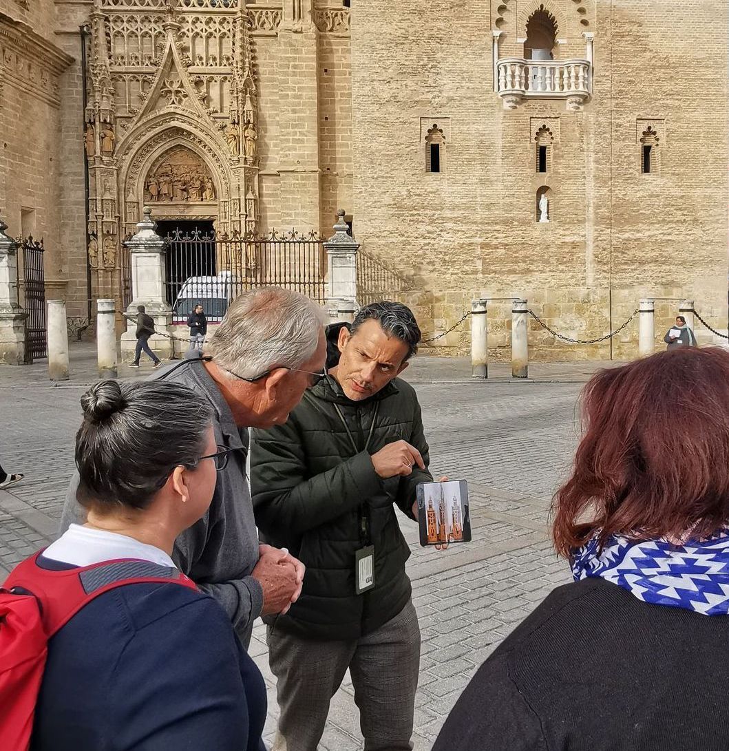 A group of people standing in a circle listening to a man