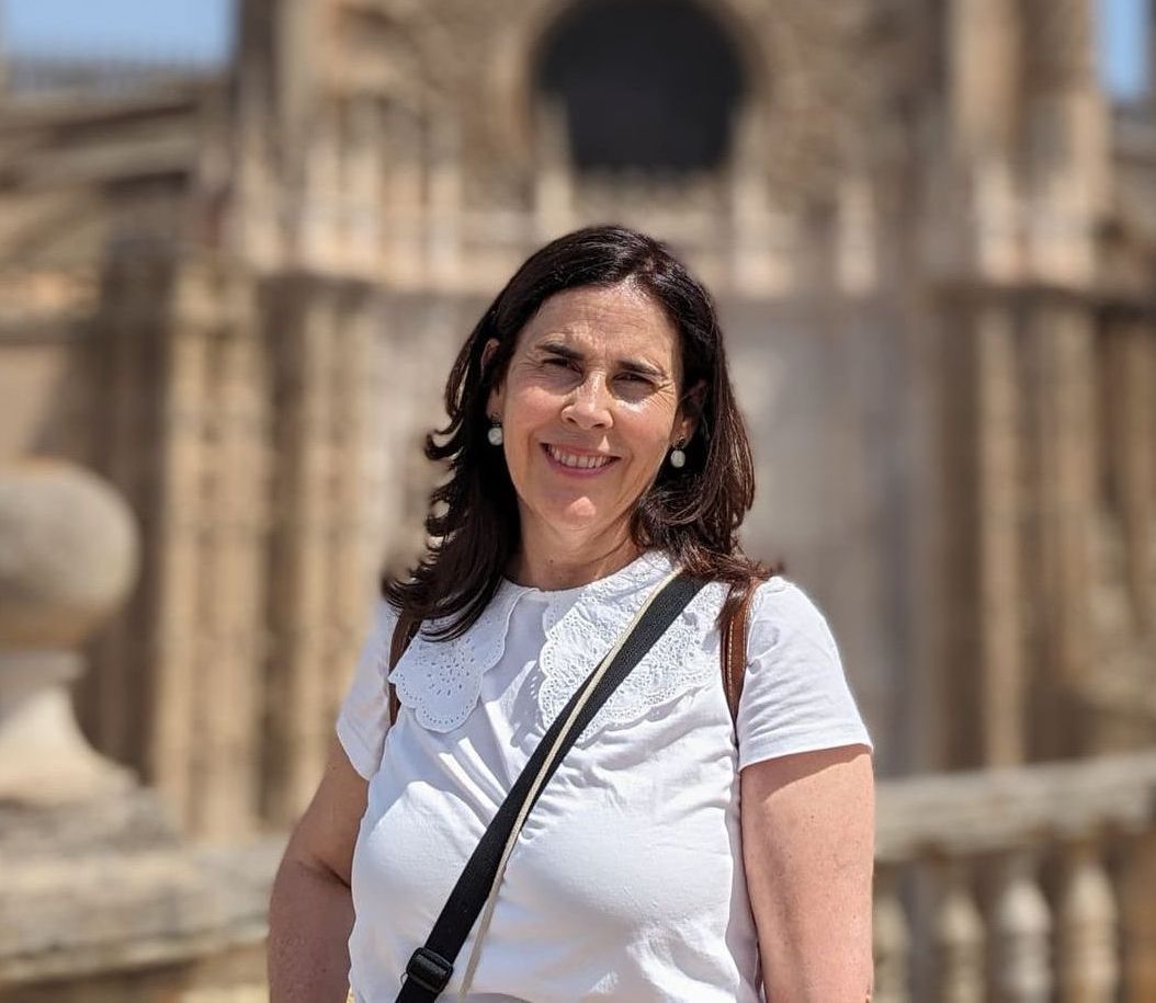 A group of people are standing in a line talking to each other