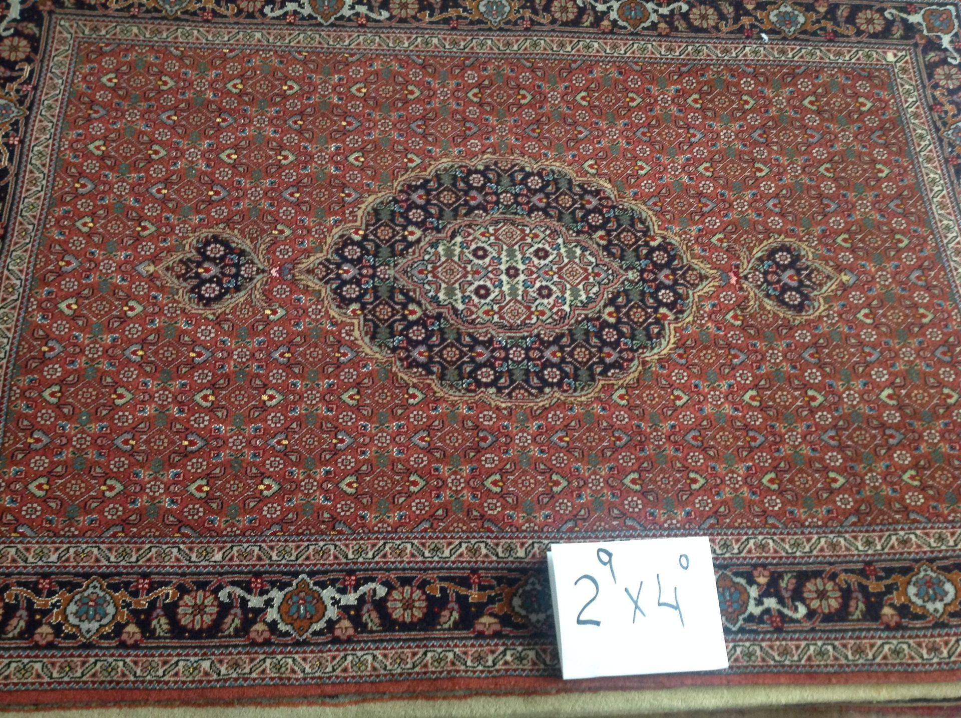 A rug with a sign that says 2 x 4 on it.