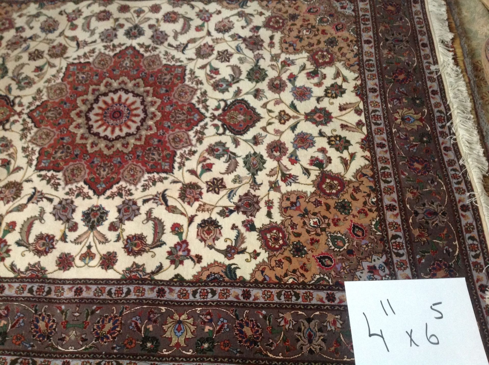 A rug with a floral pattern and a sign that says 4 x 6 on it.