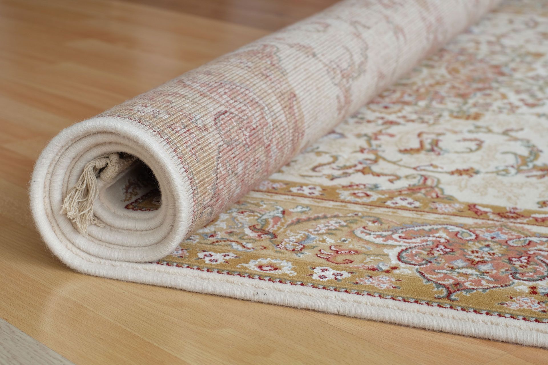 A rug is rolled up on a wooden table.