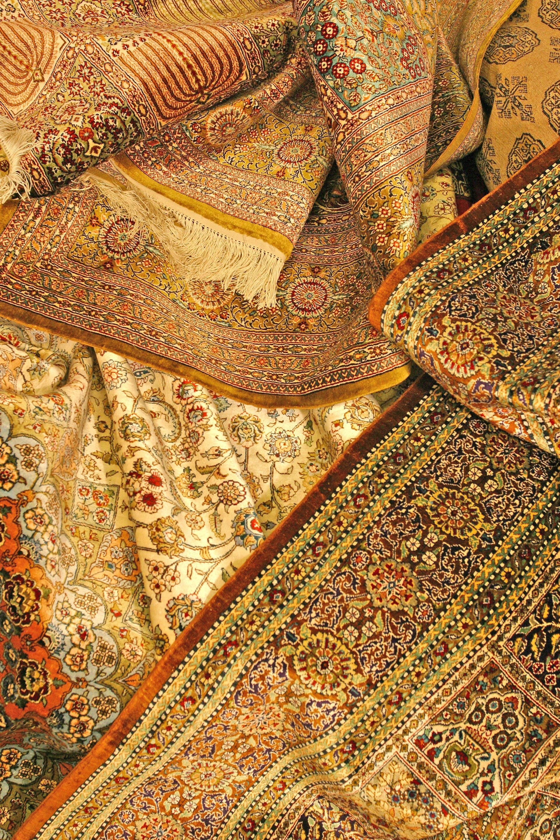 A close up of a pile of rugs on a table.