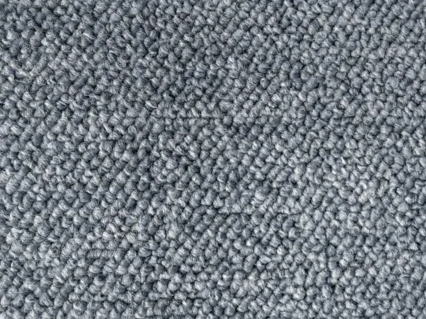 A close up of a gray carpet texture.