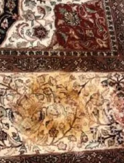 A close up of a rug with a floral pattern on it.