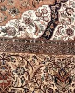 A close up of a rug with a floral pattern on it.