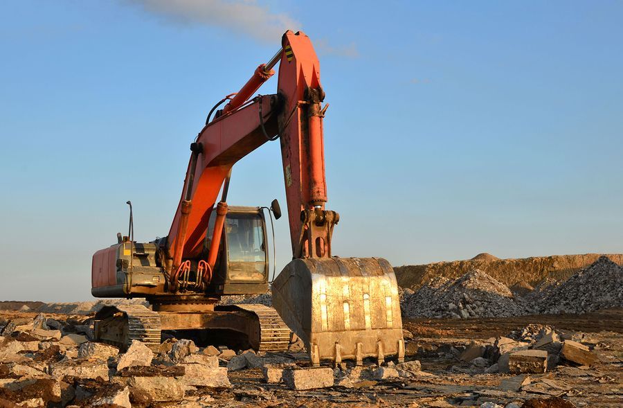 a bulldozer digging through a pile of rocks