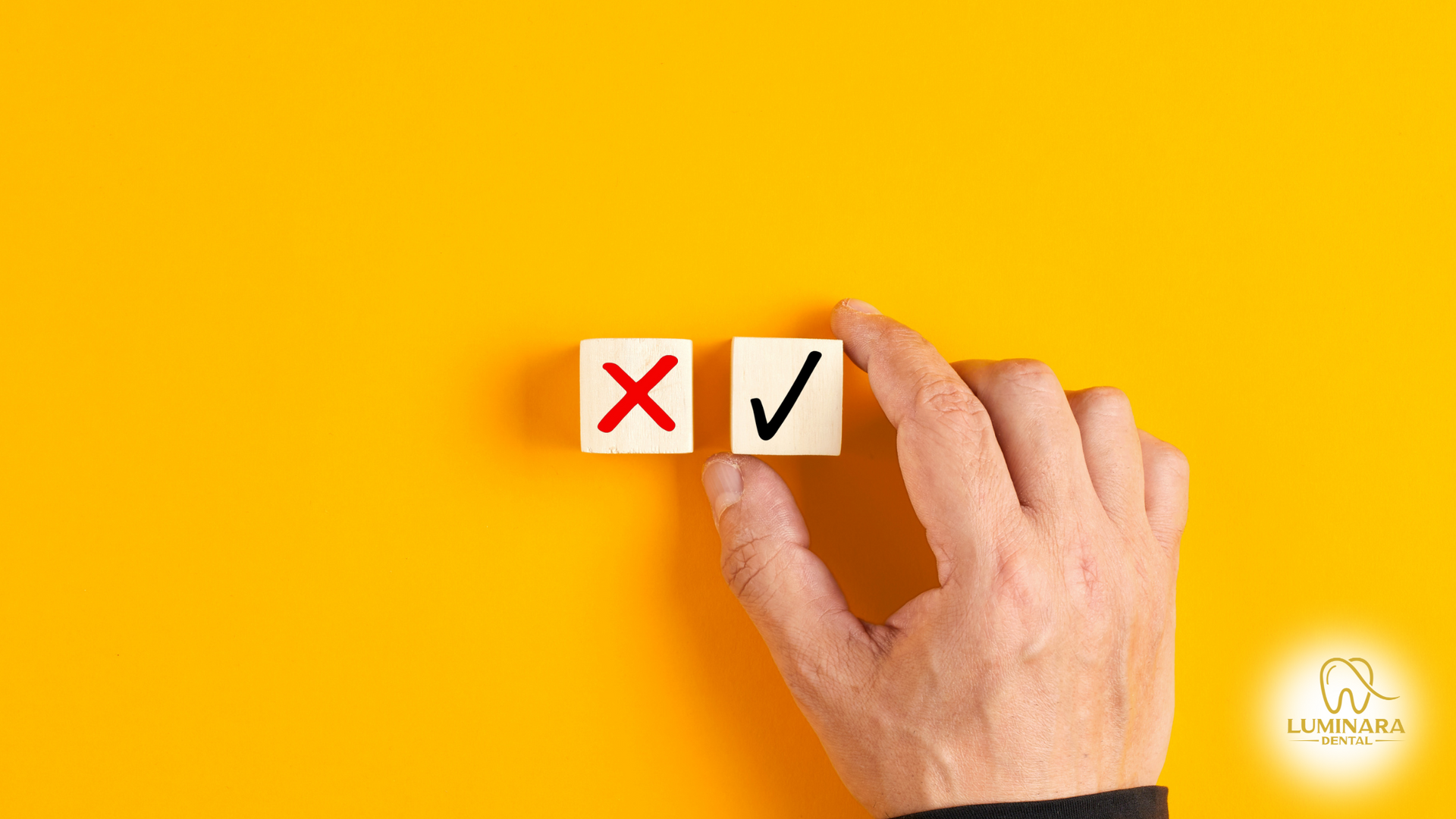 A hand is holding a check mark and an x on a yellow background.