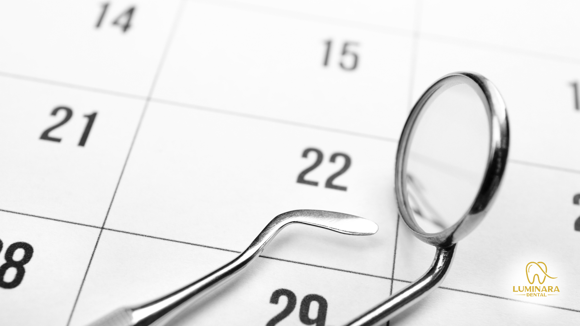 Dental tools resting on a calendar, highlighting the 22nd.