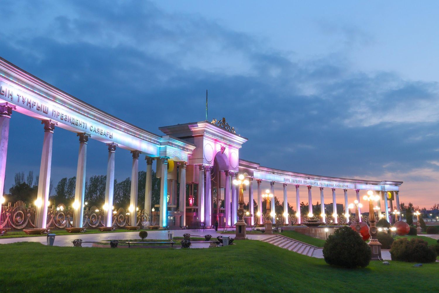 A large building with columns is lit up at night