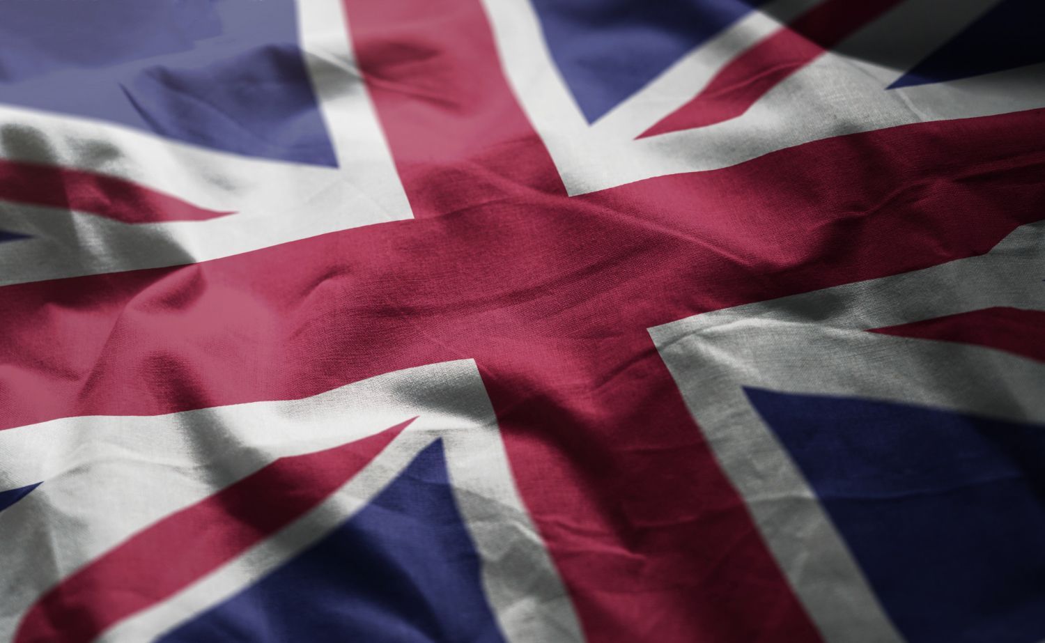 A close up of a british flag waving in the wind