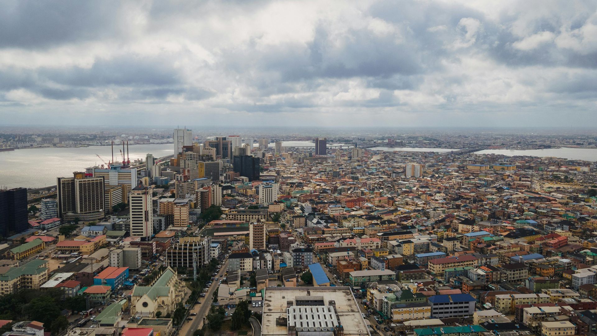 An aerial view of a large city on a cloudy day.