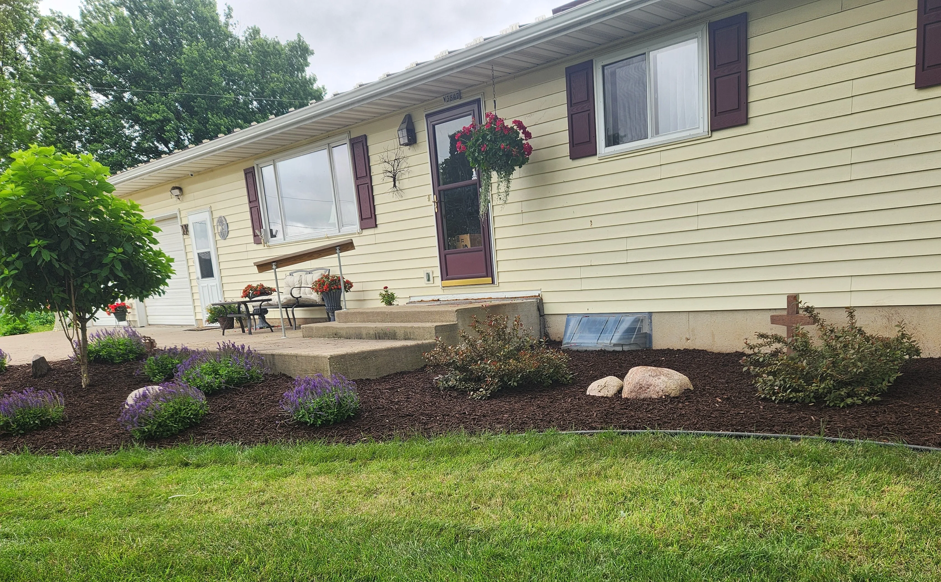 A house with a lush green lawn in front of it. A house with a lush green lawn in front of it.