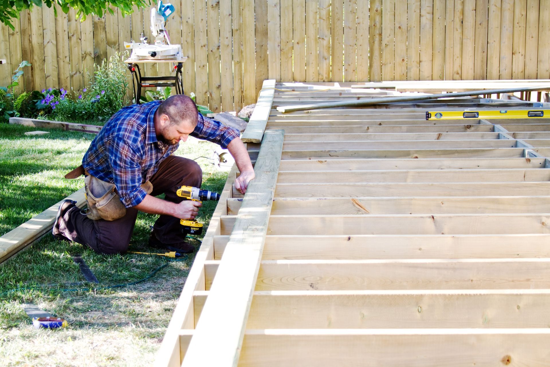 A man is building a deck.