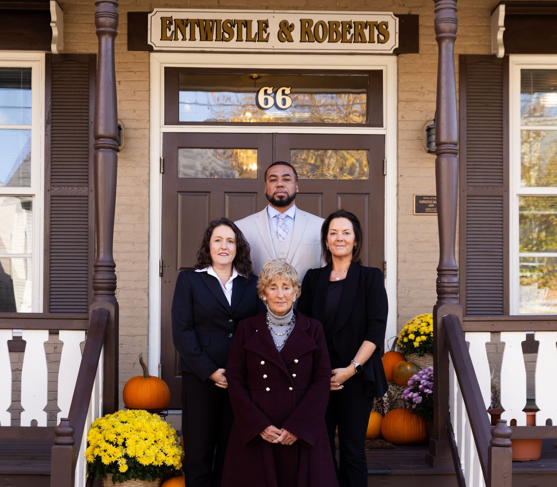 Group of people outside a law office; the sign reads 