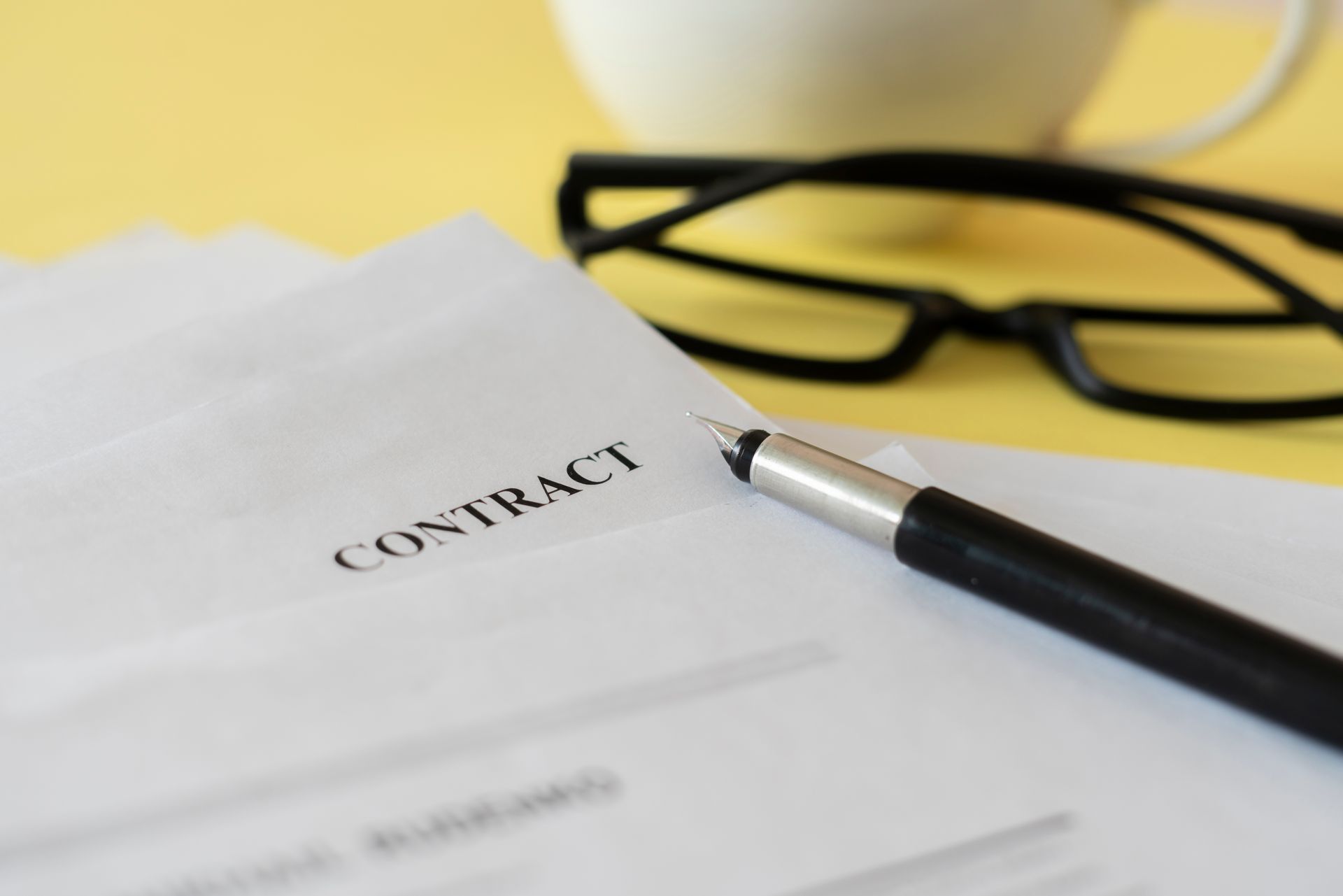 A city skyline with a bridge and an american flag in the foreground.