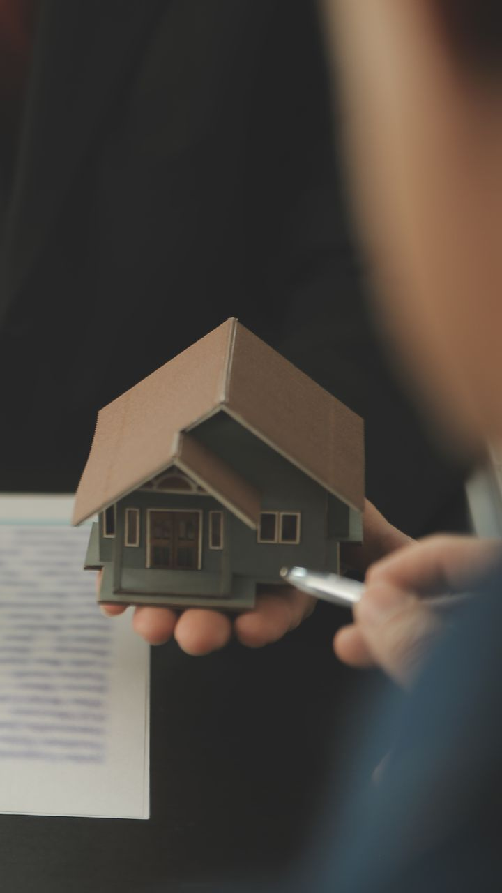 A city skyline with a bridge and an american flag in the foreground.