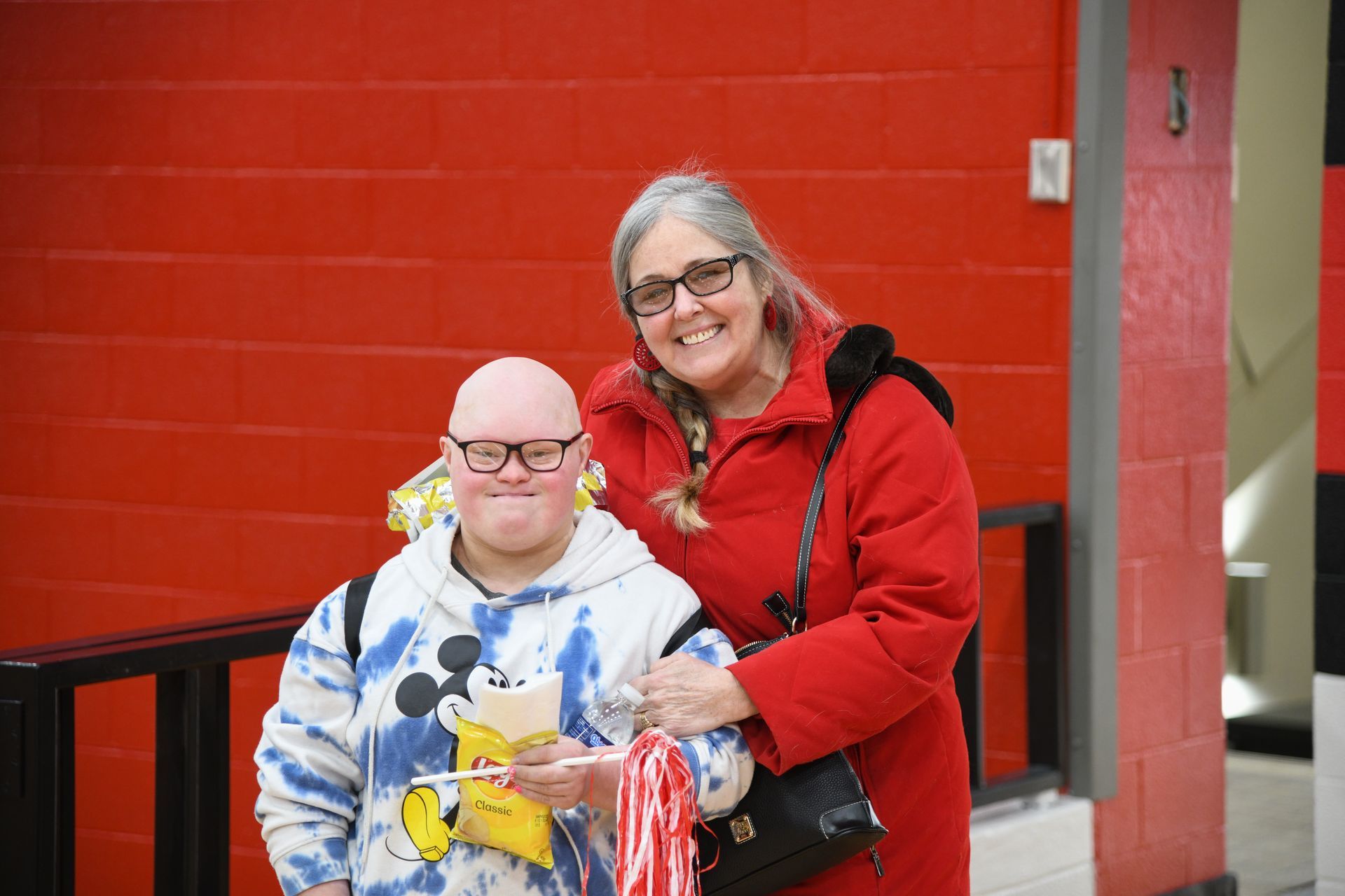 a man dressed as Captain America and a woman dressed as Wonder Woman are posing for a picture .