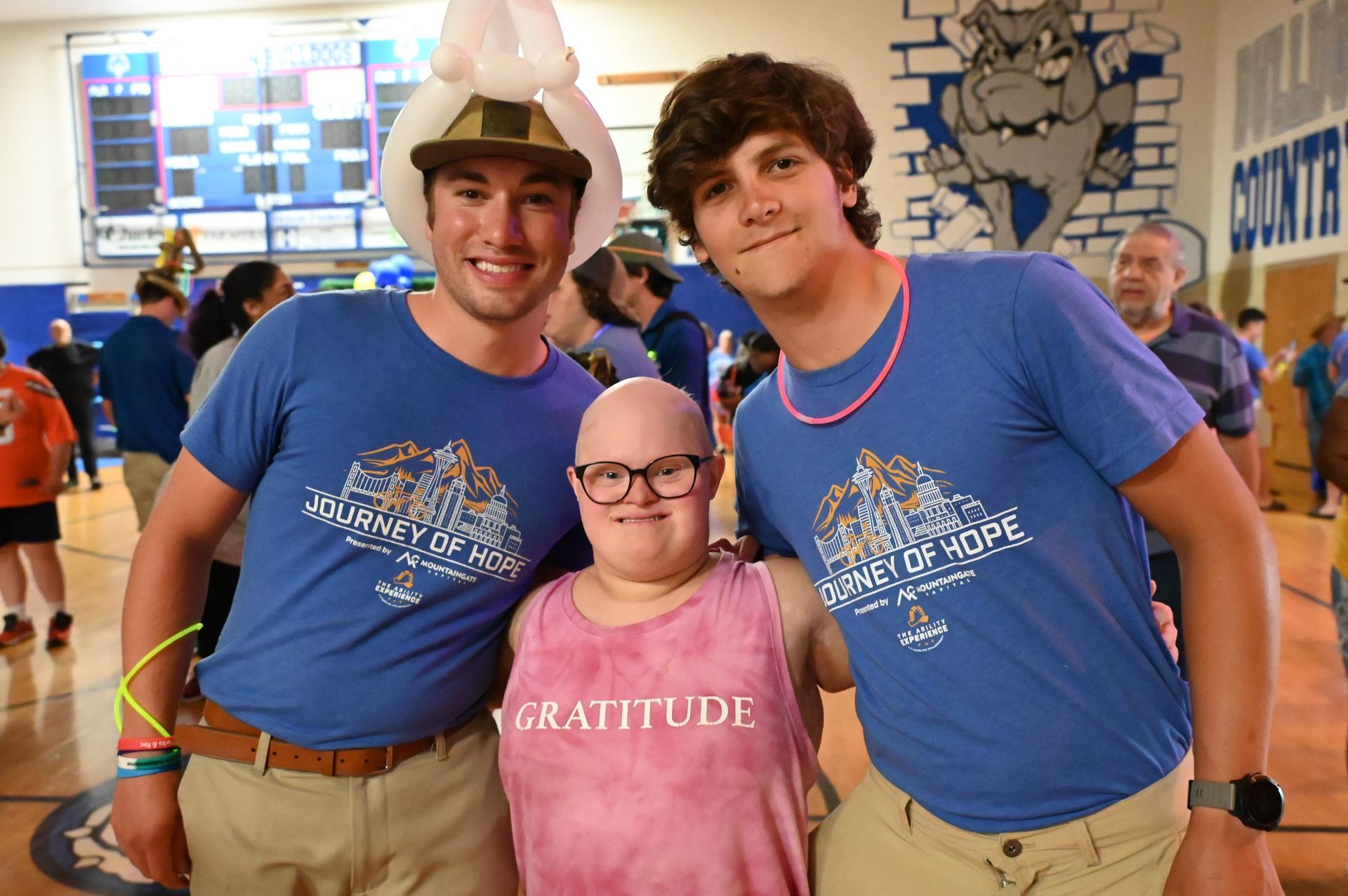a group of people posing for a picture with one wearing a shirt that says gratitude