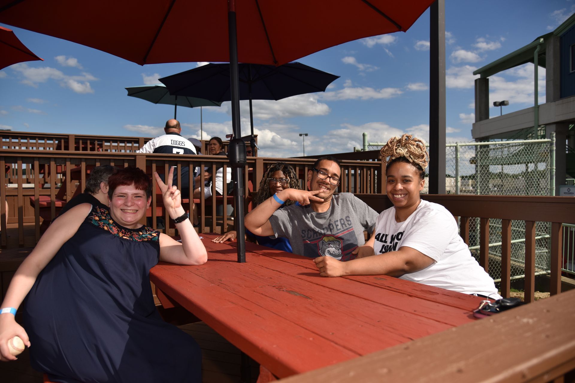a man dressed as Captain America and a woman dressed as Wonder Woman are posing for a picture .