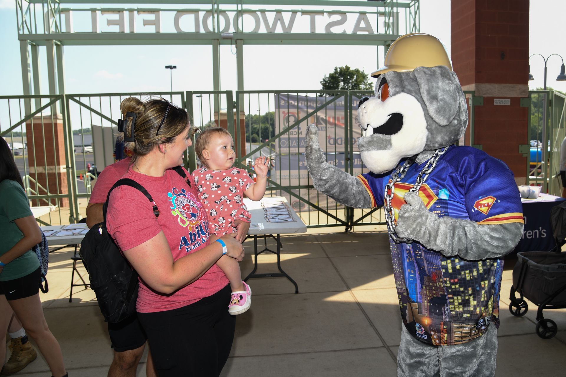 a young boy is sitting in the stands at a baseball game .