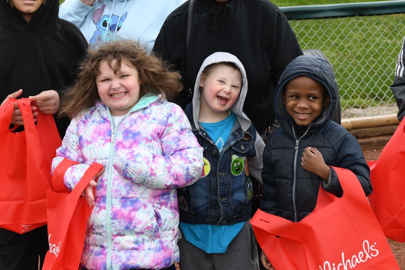 a young boy is sitting in the stands at a baseball game .
