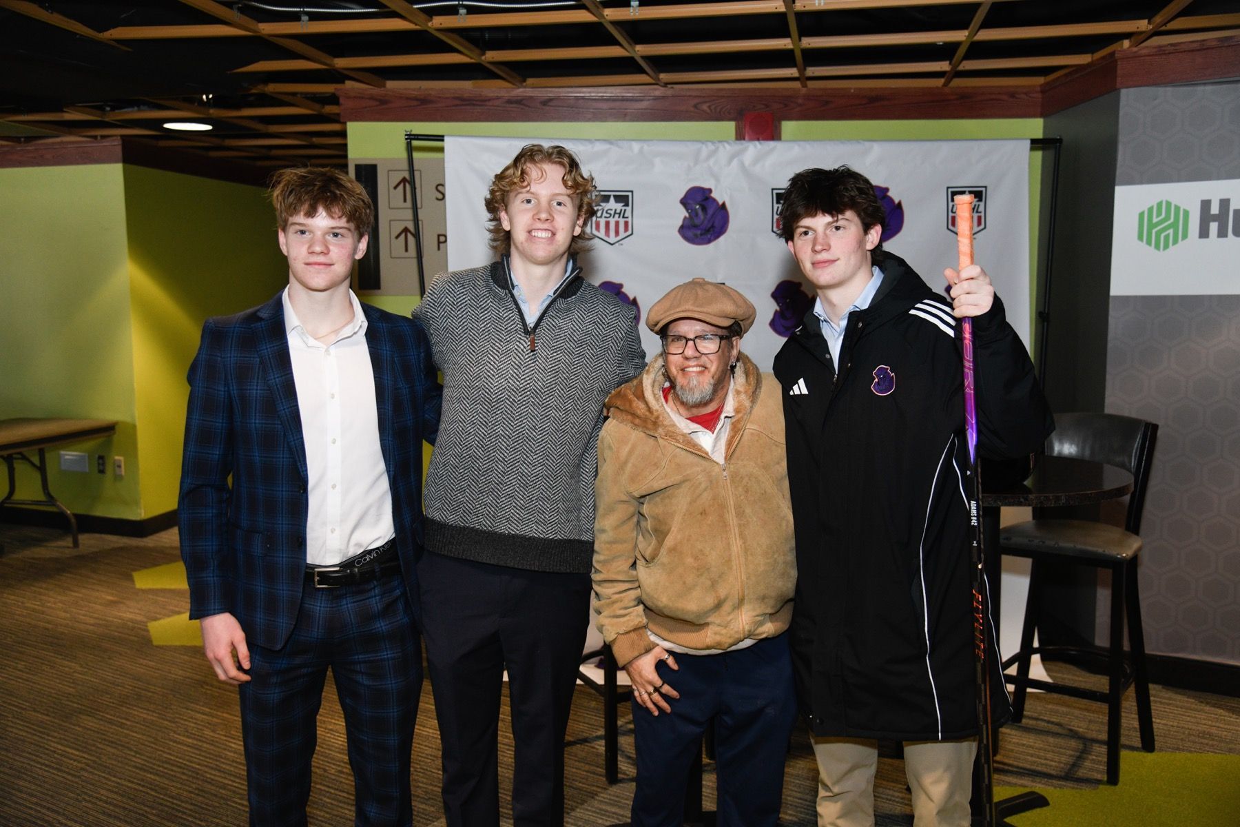 a young boy is sitting in the stands at a baseball game .