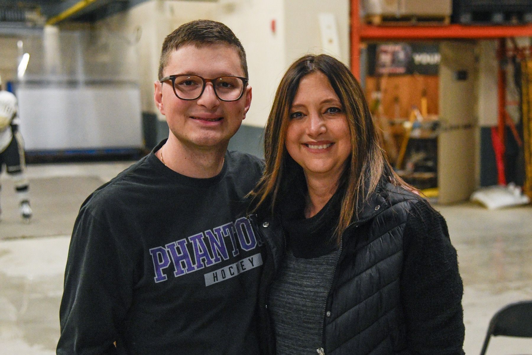 a group of people are standing on a baseball field .
